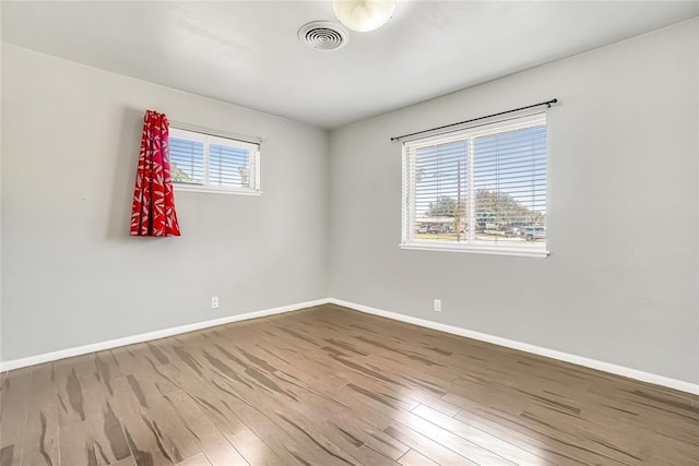 unfurnished room featuring hardwood / wood-style floors