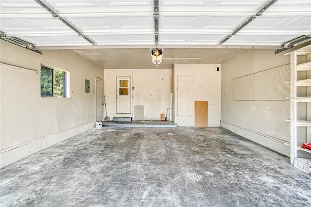 garage featuring electric panel and a garage door opener