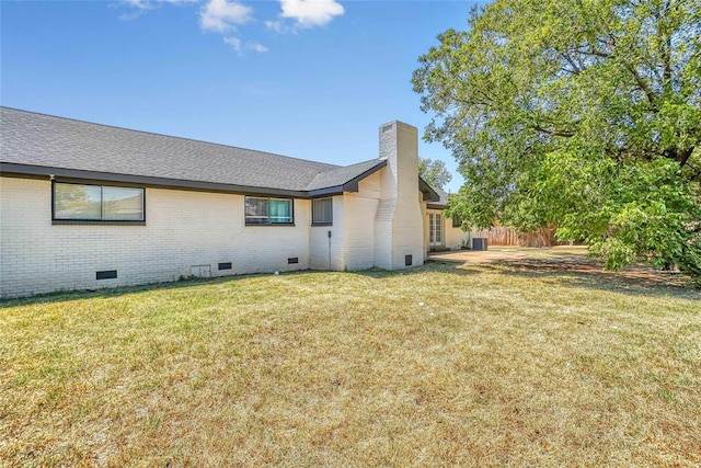 back of house with a lawn