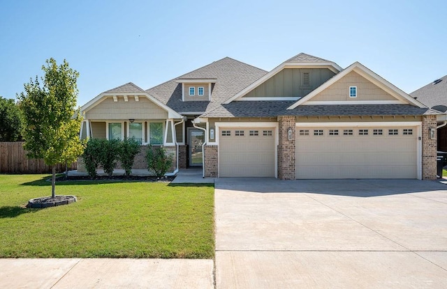 craftsman-style house featuring a garage and a front lawn