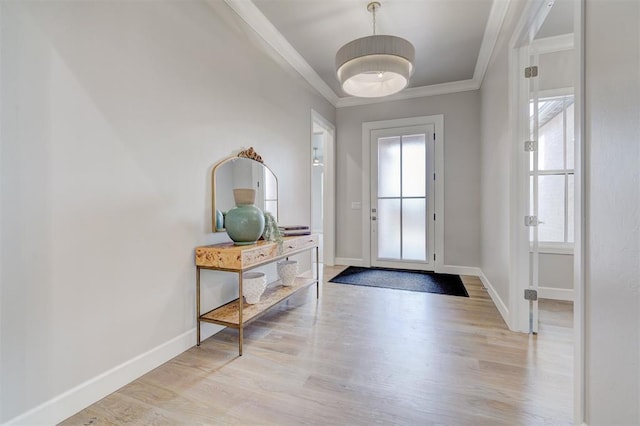 entrance foyer featuring light wood-type flooring and crown molding