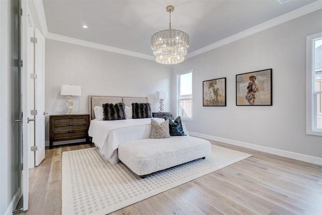 bedroom with a notable chandelier, ornamental molding, and light hardwood / wood-style flooring