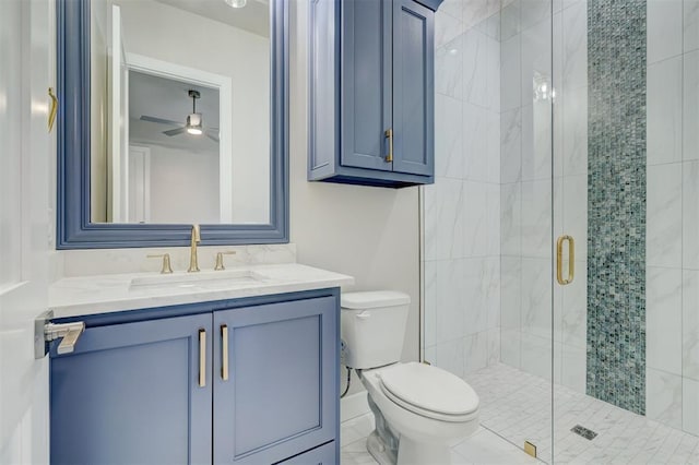 bathroom featuring a shower with door, vanity, and toilet