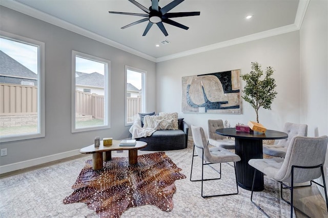 interior space with crown molding, ceiling fan, and light wood-type flooring