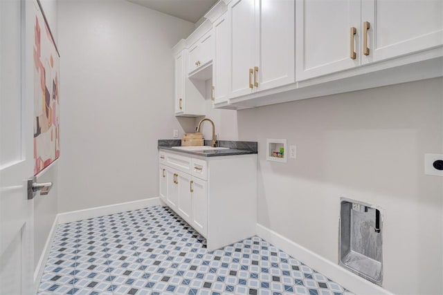 laundry area featuring hookup for a washing machine, sink, cabinets, and hookup for an electric dryer