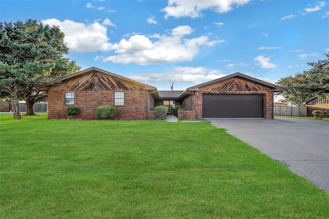 ranch-style house featuring a front yard and a garage