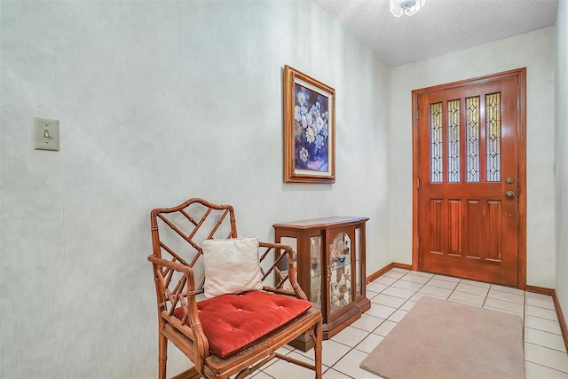 tiled foyer entrance with a textured ceiling