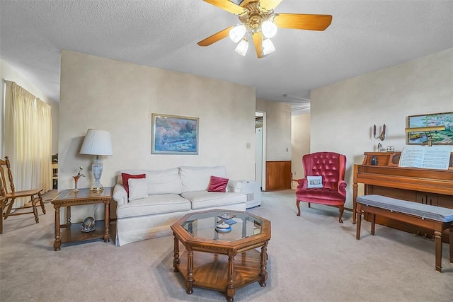 carpeted living room with a textured ceiling and ceiling fan