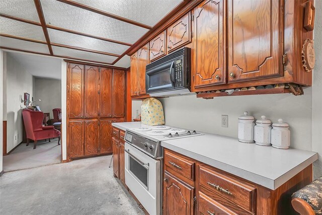 128 W Quail Dr, Cordell, OK 73632 - kitchen featuring black microwave, white electric stove, light countertops, and brown cabinetry