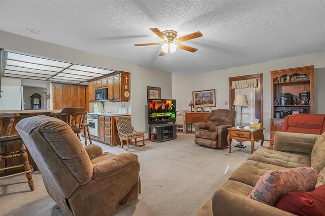 carpeted living room with ceiling fan and a textured ceiling