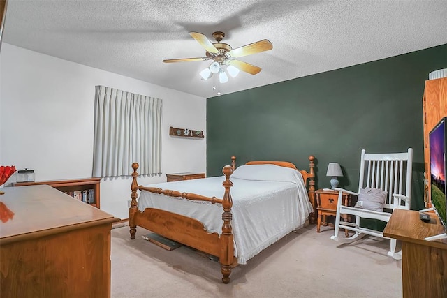 carpeted bedroom with ceiling fan and a textured ceiling