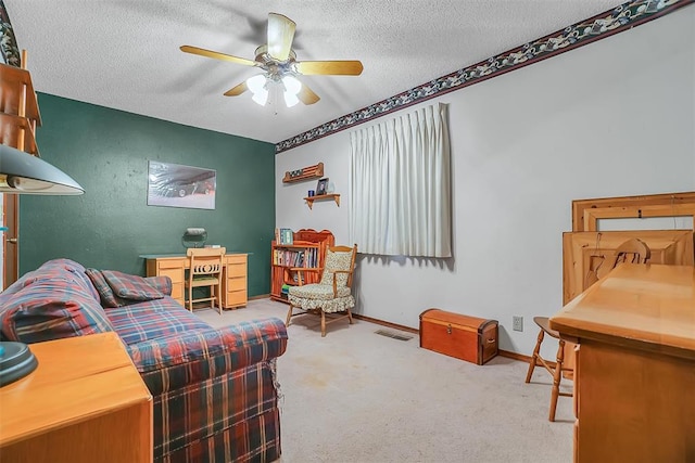 bedroom featuring carpet flooring, a textured ceiling, and ceiling fan