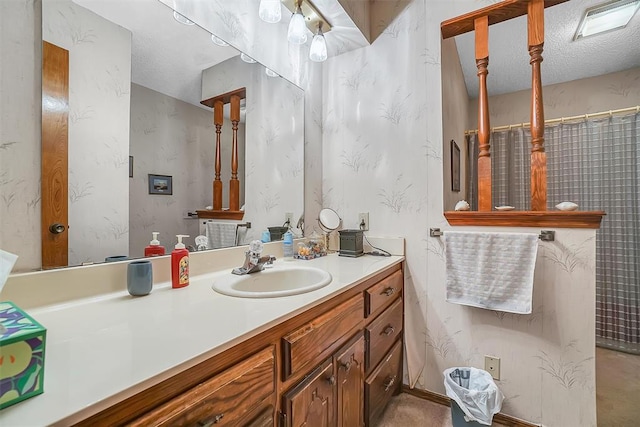 bathroom with vanity and a textured ceiling