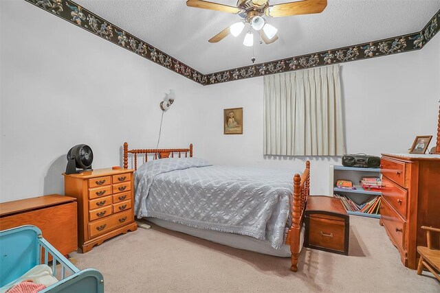 128 W Quail Dr, Cordell, OK 73632 - bedroom featuring carpet, a textured ceiling, and ceiling fan