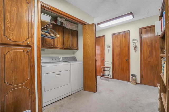 laundry room with cabinets, separate washer and dryer, and light colored carpet