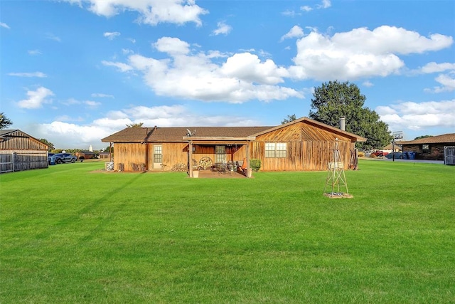 rear view of property featuring a yard