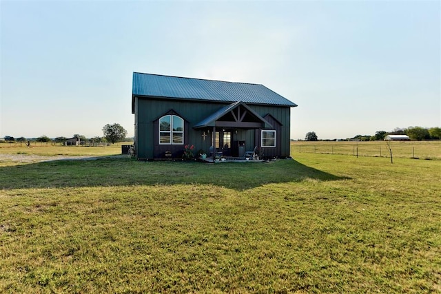 view of front of property with a front lawn and a rural view