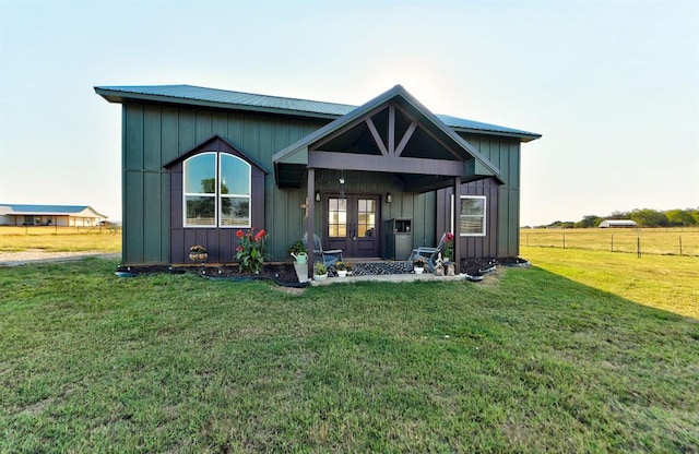 view of front facade featuring french doors and a front lawn