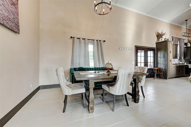 dining space with french doors, light tile patterned floors, an inviting chandelier, and ornamental molding