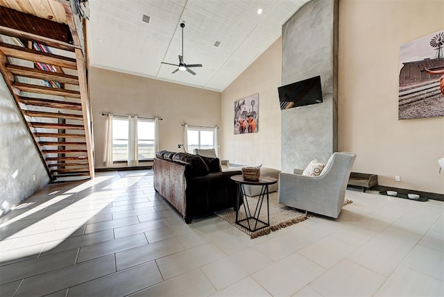 tiled living room featuring ceiling fan and high vaulted ceiling