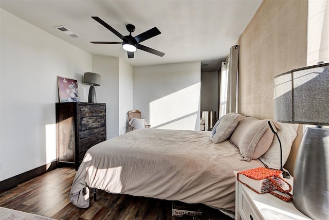 bedroom with dark hardwood / wood-style floors and ceiling fan