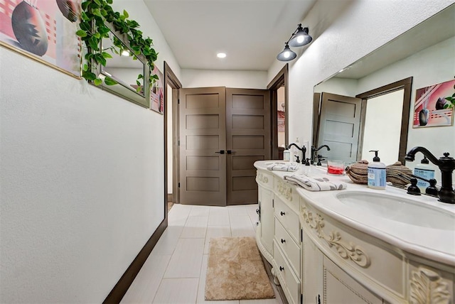 bathroom with tile patterned floors and vanity