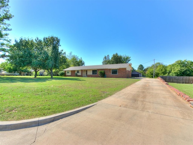 ranch-style house featuring a front yard and a garage