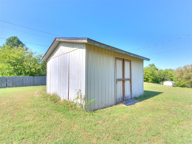 view of outbuilding featuring a lawn