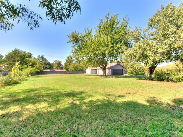 view of yard with a garage and an outdoor structure