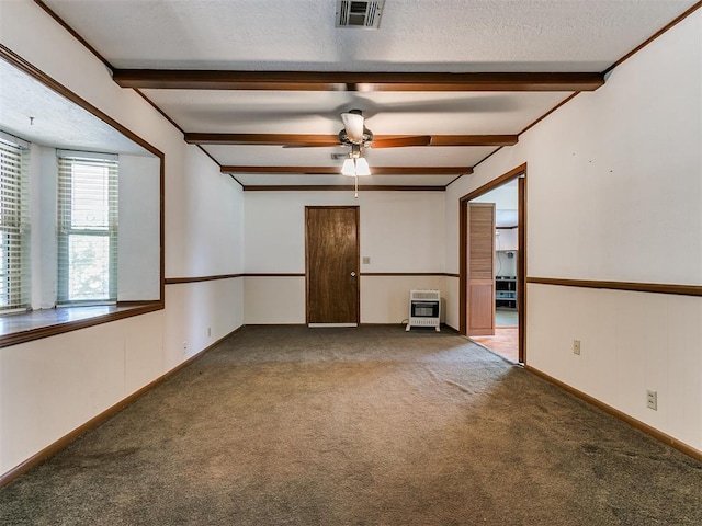 carpeted empty room featuring beam ceiling, heating unit, ceiling fan, and a textured ceiling