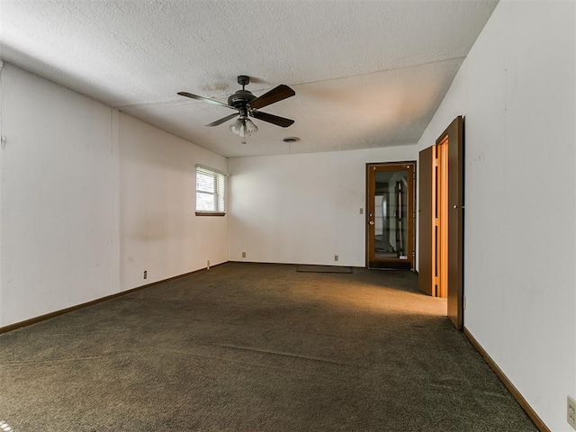 carpeted spare room with ceiling fan and a textured ceiling