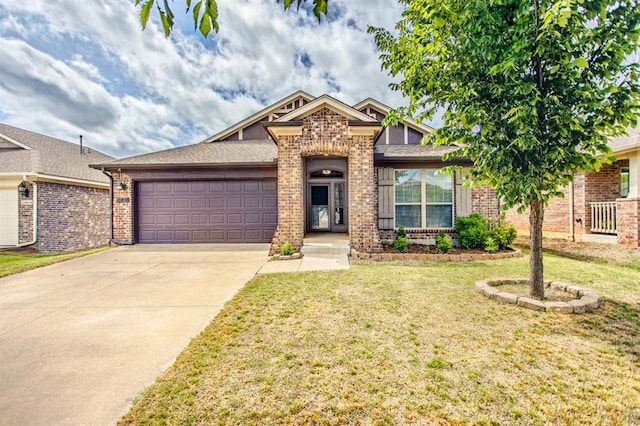 view of front of home featuring a front yard and a garage