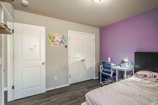 bedroom featuring dark hardwood / wood-style flooring and a closet