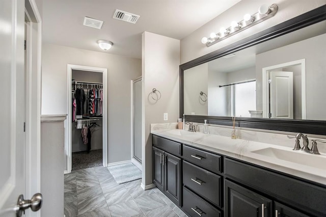 bathroom with vanity and a shower with shower door