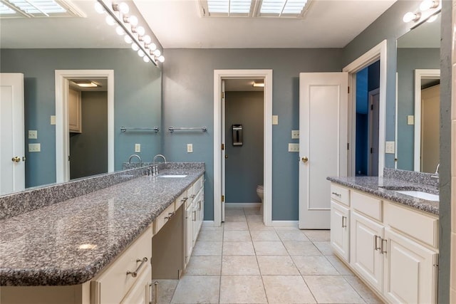 bathroom with tile patterned floors, vanity, and toilet