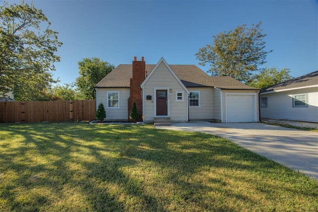 view of front of property with a front yard and a garage