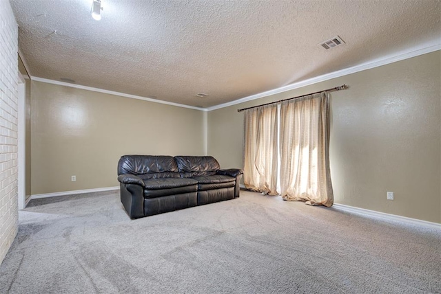 carpeted living room with a textured ceiling, a brick fireplace, and crown molding