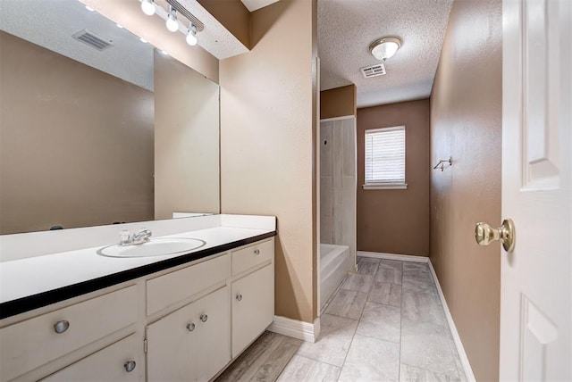 bathroom with vanity, a textured ceiling, and shower / bath combination