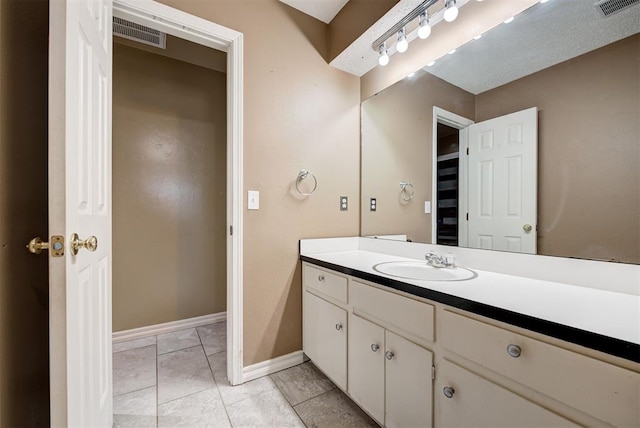 bathroom with tile patterned flooring and vanity