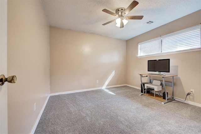 office featuring carpet flooring, ceiling fan, and a textured ceiling