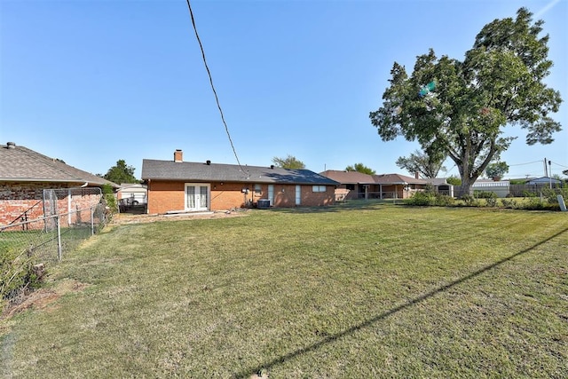 back of house with a lawn