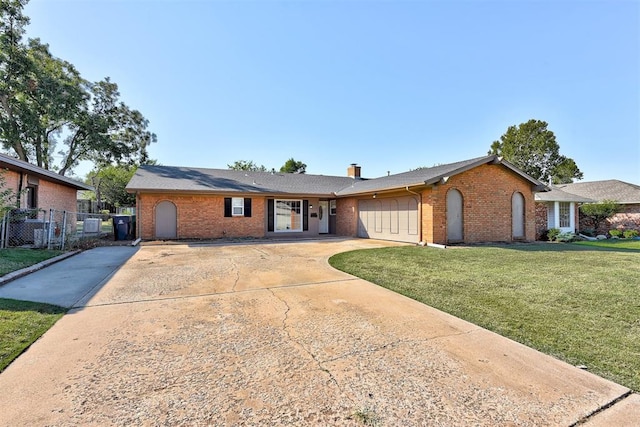 ranch-style house with a garage and a front lawn