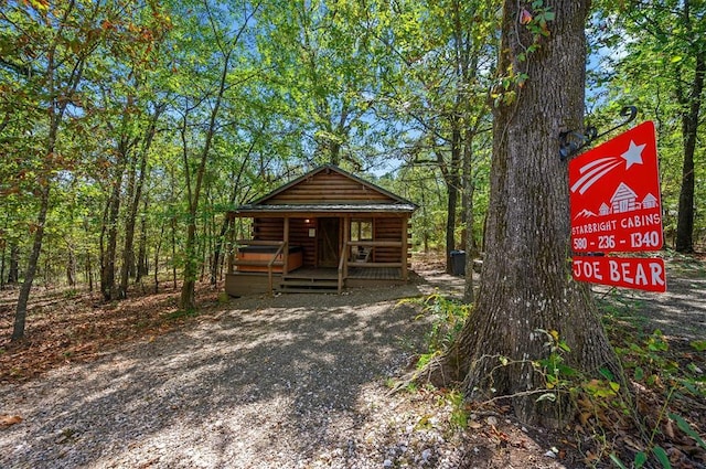 130 Wildwood Trl, Broken Bow, OK 74728 - view of front of home with log exterior and covered porch