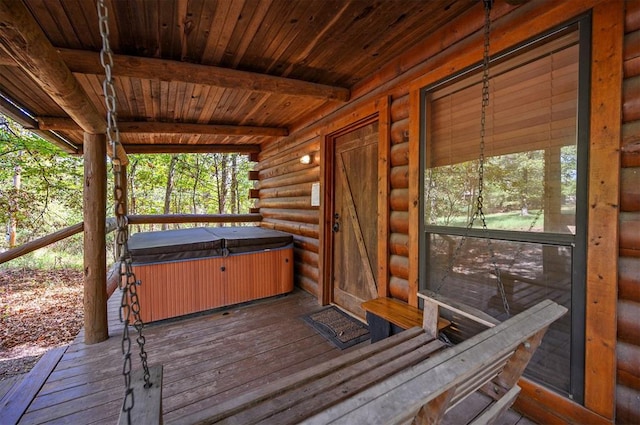 wooden terrace with a hot tub