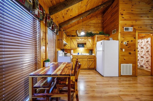 kitchen with white appliances, light hardwood / wood-style floors, high vaulted ceiling, and hanging light fixtures