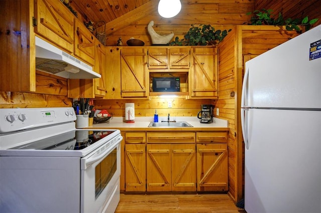 kitchen with wood ceiling, white appliances, sink, light hardwood / wood-style floors, and wood walls