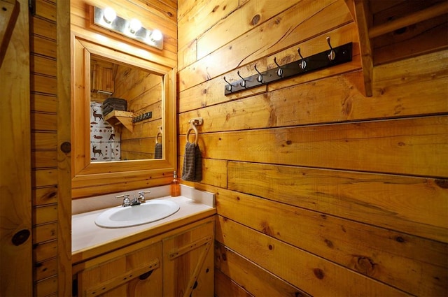 bathroom featuring wood walls and vanity