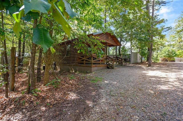 130 Wildwood Trl, Broken Bow, OK 74728 - view of property exterior with log siding and a deck