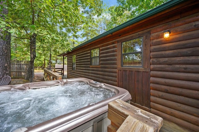 wooden deck with a hot tub