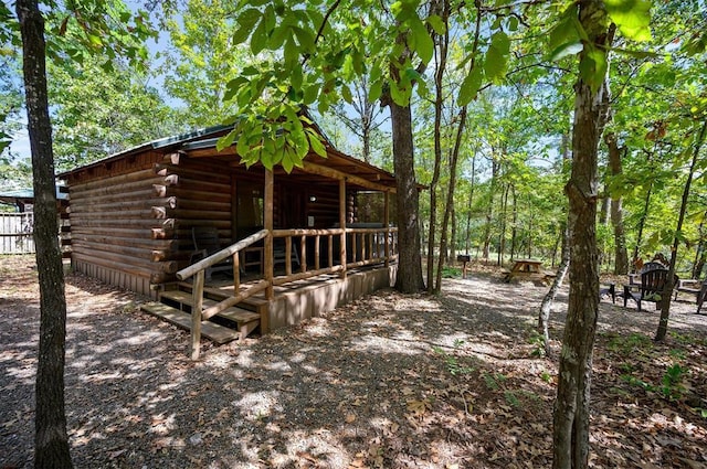 130 Wildwood Trl, Broken Bow, OK 74728 - view of side of home featuring log siding and an outbuilding